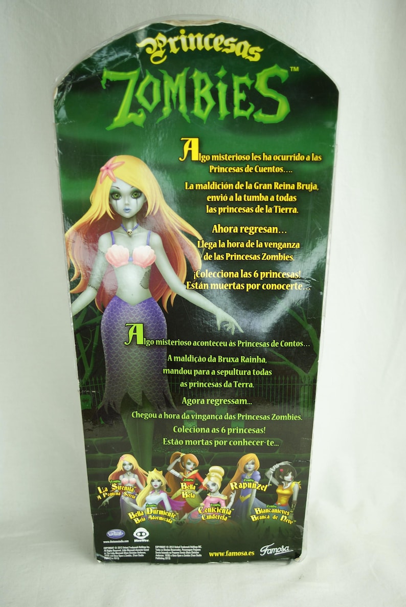 May include: A Princesas Zombies toy packaging featuring a mermaid doll with long blonde hair, a pink seashell top, and a purple tail. The green background displays text in Spanish and Portuguese, along with images of six different doll characters.