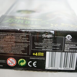 May include: A rectangular black cardboard toy packaging box featuring white text, safety warnings, and a barcode. The box includes the Famosa and WowWee logos, a 4+ age rating, and manufacturing information printed in multiple languages on the side panel.