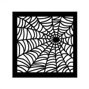May include: A black and white spiderweb design within a square frame. The web features curved lines radiating from a central point, creating a symmetrical pattern. The design is suitable for Halloween or spooky-themed crafts.