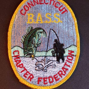 May include: A set of three ceramic mugs with a speckled, cream-colored glaze. Each mug features a different hand-painted floral design in shades of blue, green, and yellow. The mugs have a simple, rounded shape and a comfortable handle.