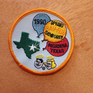 May include: A blue and orange embroidered patch with the text "1990 Spring Have Fun Samoree Pasadena Texas". The patch features a green outline of the state of Texas with a white star and three balloons.