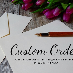 May include: A white sheet of paper with the text "Custom Order" written in black cursive font. Below the text is the phrase "Only order if requested by a Pixum Ninja" in black font. A wooden and gold fountain pen is lying on the paper.