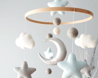 Móvil para bebé neutro, de piel sintética y fieltro, con bolas de lana, ideal como regalo de baby shower para niños y niñas.