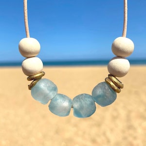 Sea glass necklace, blue recycled glass beads with white wooden beads and brass rings on leather cord. Beach glass necklace gift for her