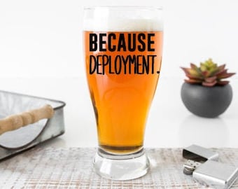 May include: A clear glass beer mug with a black inscription that reads "Because Deployment."