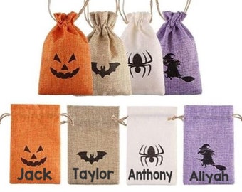 May include: Set of six Halloween-themed burlap gift bags with different designs, including a pumpkin, bat, spider, and witch. Each bag has a name printed on the bottom: Jack, Taylor, Anthony, Aliyah.