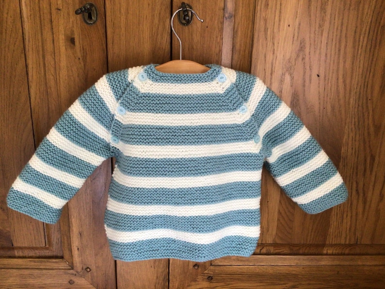 Baby\u2019s hand knitted Breton style jumper in pale blue and white 912 months approx .