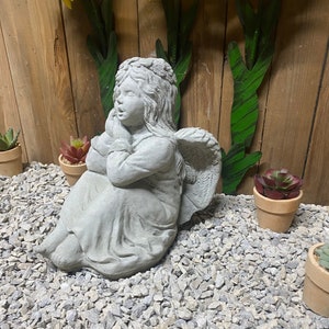 Sitting angel concrete statue