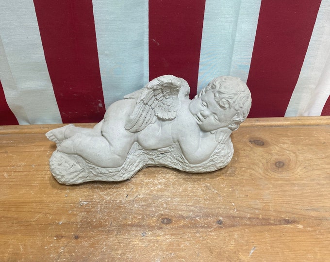 Laying boy angel concrete statue