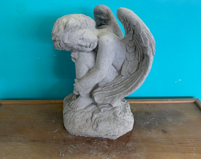Angel on rock concrete statue
