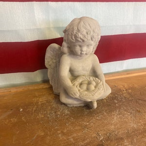 Angel with bird nest concrete statue