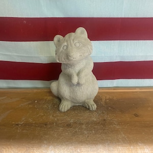 Standing raccoon concrete statue