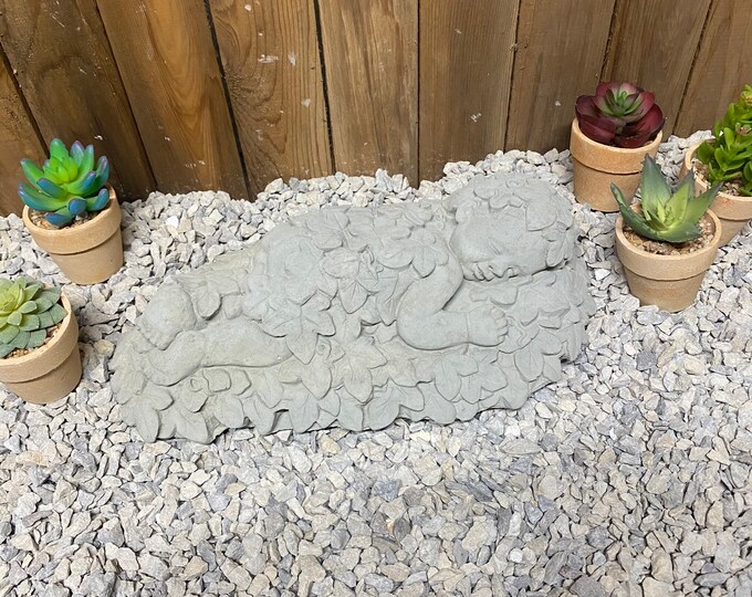 Baby laying in leaves concrete memorial, indoor/ outdoor cement statue