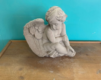 Sideways angel concrete statue