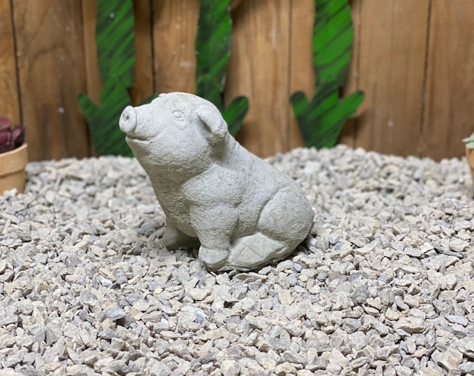 Cute sitting pig concrete statue