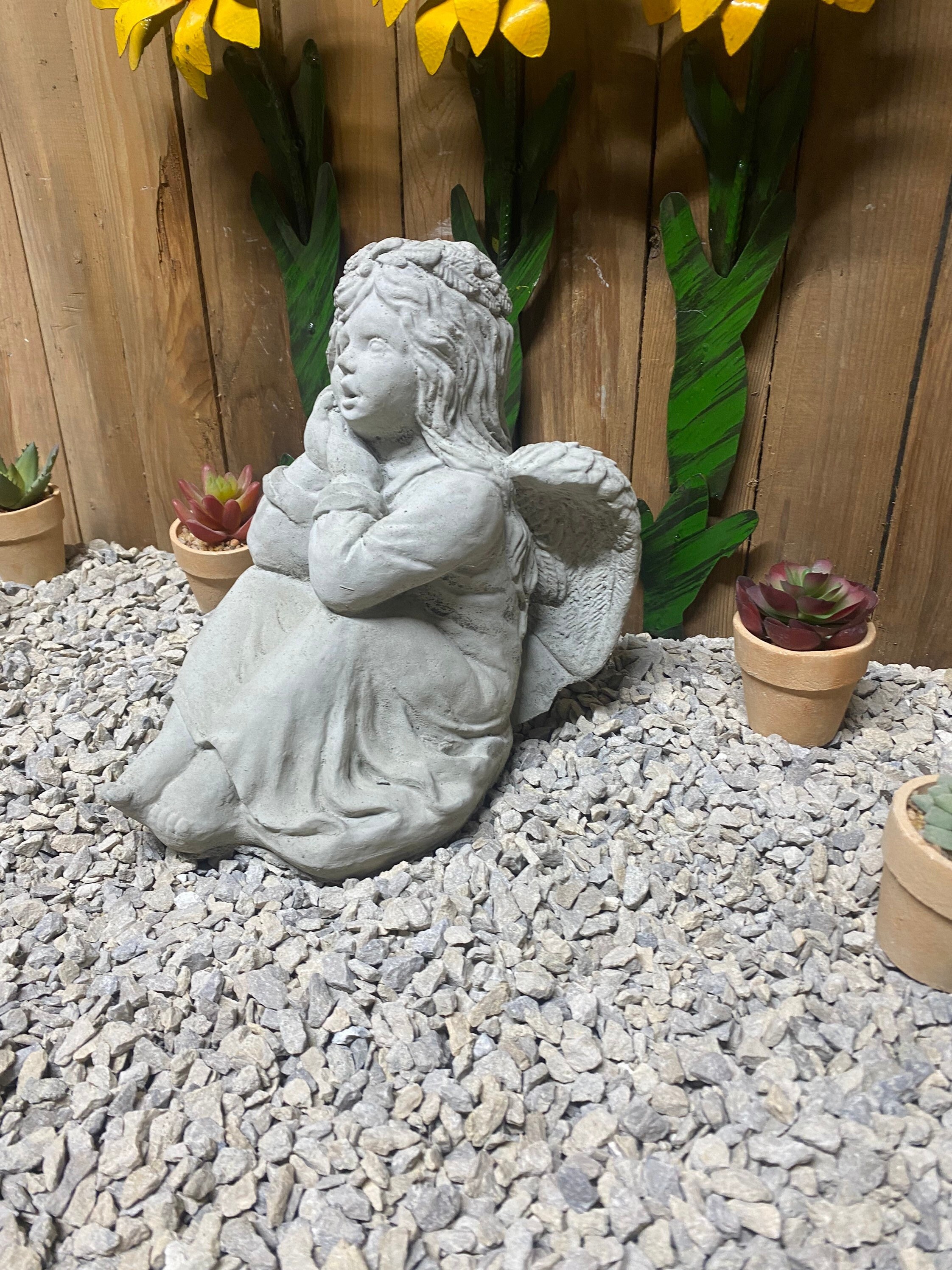 Sitting angel concrete statue