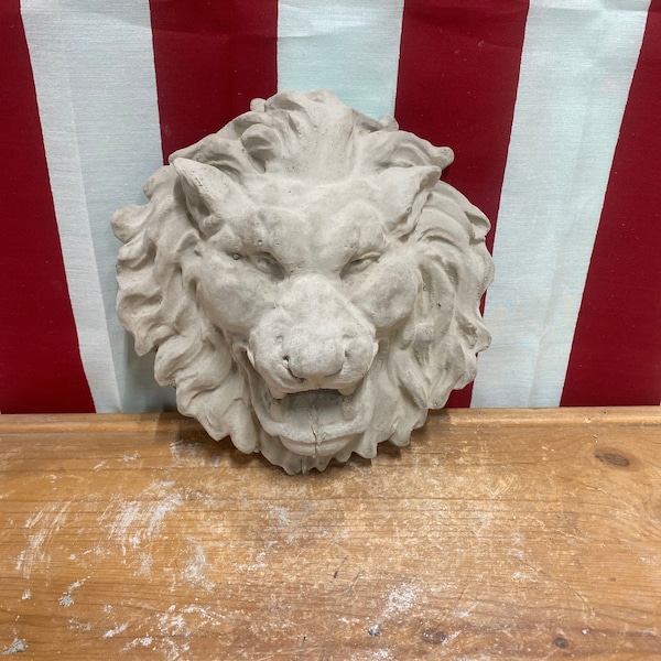 Hanging lion face concrete statue