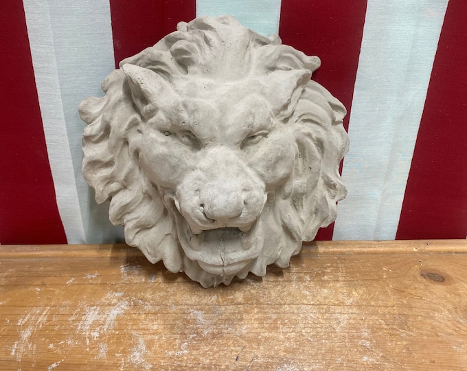 Hanging lion face concrete statue