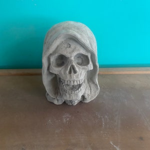 Grim reaper head concrete statue