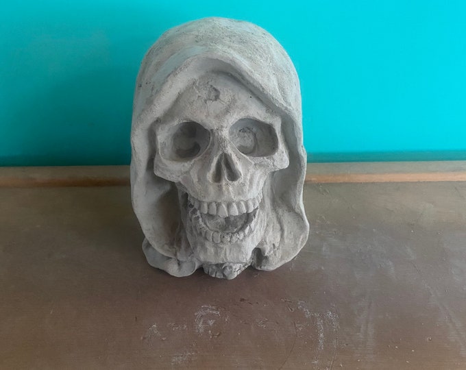 Grim reaper head concrete statue