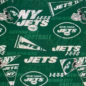 May include: Green fabric with a repeated pattern of the New York Jets logo. The logo is white with black outlines and the words "New York Jets" and "Gotham City Football" are included in the design.