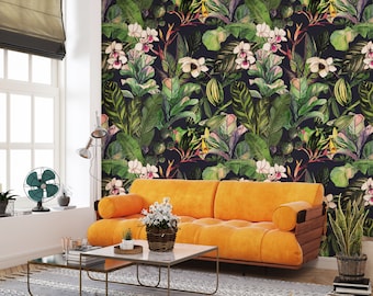 May include: A living room with a bright orange sofa and a coffee table in front of it. The wall behind the sofa is covered in a tropical wallpaper with green leaves and white flowers.