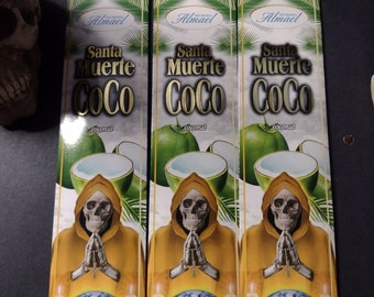 May include: Three boxes of incense sticks featuring a skull image and the text "Santa Muerte Coco" in gold lettering. The boxes are white with green palm leaves and a coconut image. Each box contains 20 sticks and has the text "LARGA DURACION" and "CONTENIDO NETO 20g".