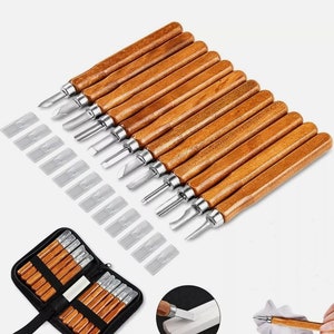 May include: A set of 18 wood carving tools with wooden handles and metal blades, organized in a black zippered case. The tools are arranged in a row, with the blades facing up. The tools are accompanied by a sharpening stone and a cloth.