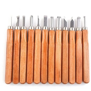 May include: Set of 15 wood carving tools with wooden handles. The tools have different shapes and sizes for various carving techniques.
