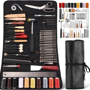 May include: A black leathercraft tool kit with a variety of tools, including a mallet, scissors, needles, and thread spools. The kit includes a measuring tape, a ruler, and a knife. The tools are organized in a black roll-up case.