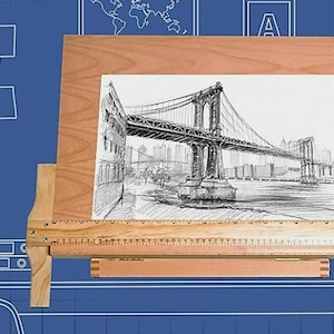 May include: A wooden drawing board with a ruler and a drawing of the Brooklyn Bridge. The drawing board is made of light wood and has a dark brown finish. The ruler is made of wood and has a metal edge. The drawing is in black and white and shows the bridge in detail.