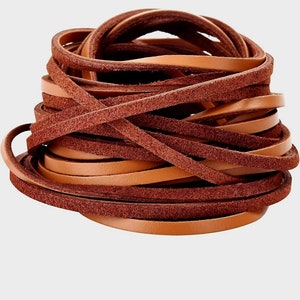 May include: A bundle of brown leather cord, some strands are smooth and some are suede.