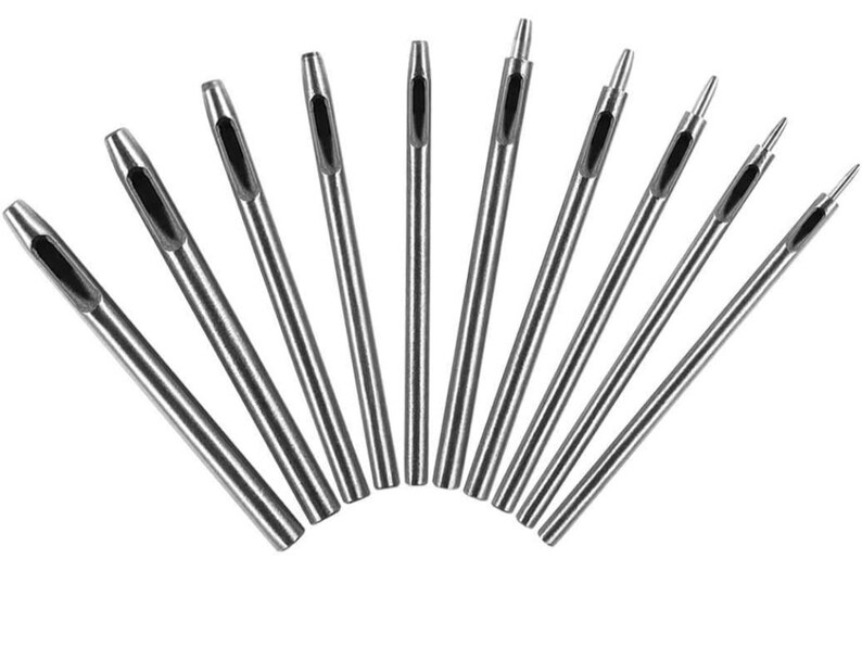 May include: Set of 10 silver metal hole punch tools with different sized holes. The tools are arranged in a fan shape.