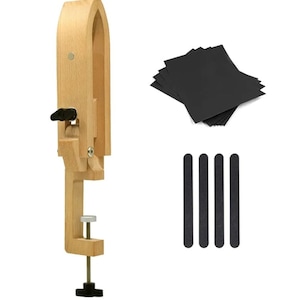 May include: A wooden clamp with a black handle and a silver knob. The clamp is used for holding leather while working on it. The image also shows black sandpaper and sanding sticks.