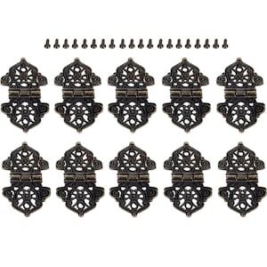 May include: Ten antique gold-toned metal hinges with intricate filigree designs. Each hinge has two parts that connect with a small metal pin. The hinges are accompanied by twenty small screws.