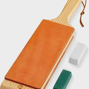 May include: A wooden leather strop with a handle and a white and green polishing compound.