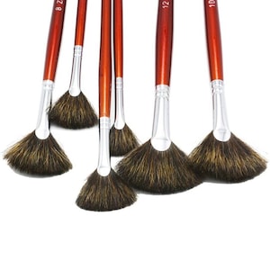 May include: Set of six fan-shaped paint brushes with brown wooden handles and silver metal ferrules. The handles are labeled with the numbers 8, 10, 12, and 14.
