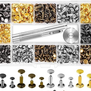 May include: A set of metal rivets in a clear plastic storage box. The box contains six compartments, each filled with a different color of rivets. The rivets are in various sizes and shapes. The box also includes a tool for setting the rivets.