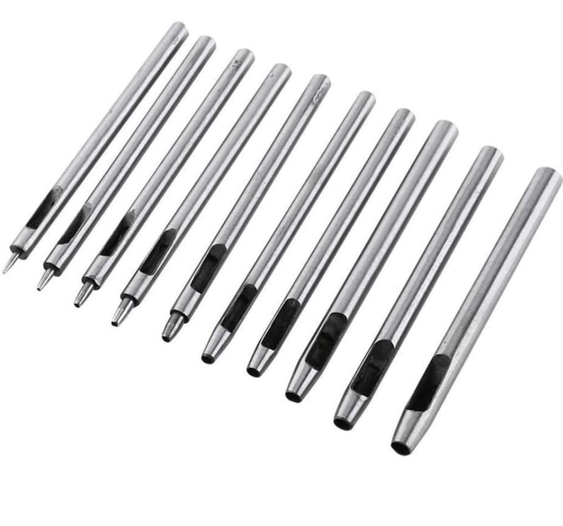 May include: Set of ten silver metal leather hole punch tools. The tools are different sizes and have a rounded tip.