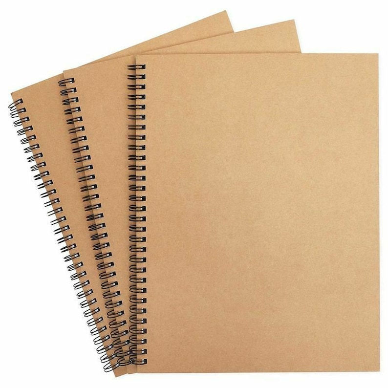May include: Three brown spiral bound notebooks with black wire binding.