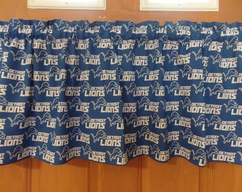 May include: Blue and white valance with a repeating pattern of the Detroit Lions logo.