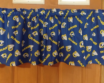 May include: Blue and yellow valance with a repeated pattern of the word "RAMS" and a stylized ram's head.