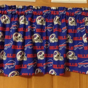 May include: Blue and red fabric valance with a repeating pattern of the Buffalo Bills logo and the word "Bills".
