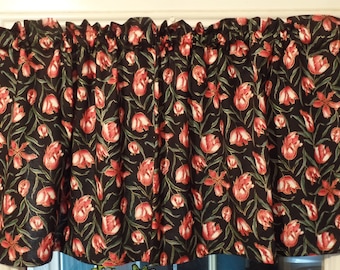 May include: Black valance with a red and white tulip pattern. The valance has a ruffled edge.