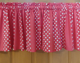 May include: Red and white polka dot valance with a ruffled edge. The valance is made of a cotton fabric and has a white background with red polka dots.