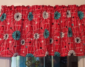 May include: Red and white valance with a geometric pattern of black lines and turquoise circles. The circles have a starburst design.