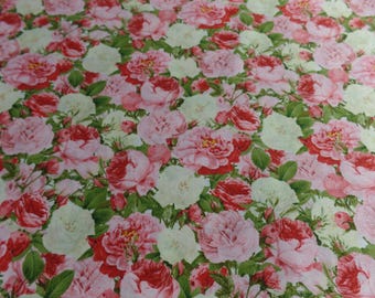 May include: A floral fabric with a repeating pattern of pink and white roses on a light green background.