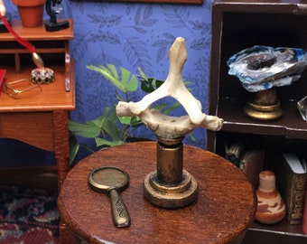 miniature creature vertebra on display stand in 1:12 scale