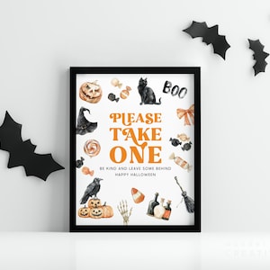 May include: A framed Halloween-themed print with a black border. The print features watercolor illustrations of a black cat, pumpkins, candy, and a witch's hat. The text reads "PLEASE TAKE ONE" and "BE KIND AND LEAVE SOME BEHIND HAPPY HALLOWEEN."