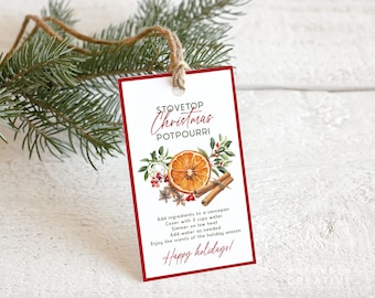 May include: A rectangular tag with a red border and the words "Stovetop Christmas Potpourri" in elegant script. The tag features a watercolor illustration of an orange slice, cinnamon sticks, and spices. The tag is tied with twine and adorned with evergreen branches.